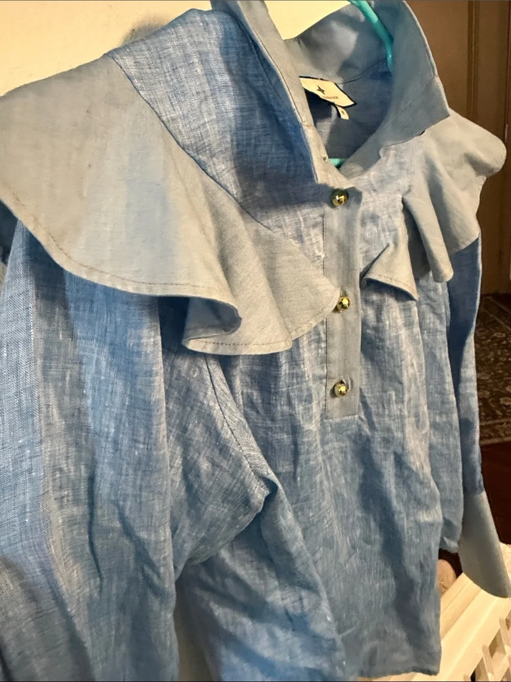 Tuckernuck Mirabella ruffle bib blouse in chambray blue linen.